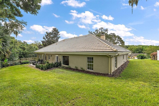 back of house with a lawn