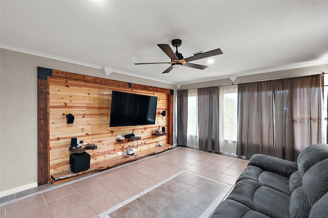 tiled living room featuring crown molding, wooden walls, and ceiling fan