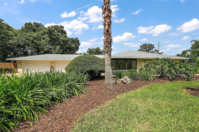 view of home's exterior with a yard and a garage