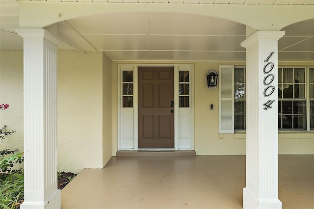 view of exterior entry featuring a porch