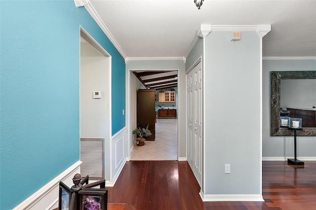 corridor with ornamental molding and dark hardwood / wood-style flooring