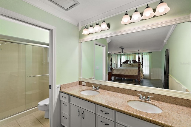 bathroom with vanity, tile patterned flooring, toilet, and an enclosed shower