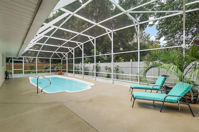 view of swimming pool featuring a patio and glass enclosure