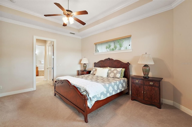 bedroom with ornamental molding, light colored carpet, connected bathroom, and ceiling fan