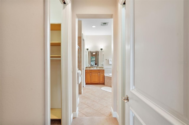 corridor featuring light tile patterned flooring