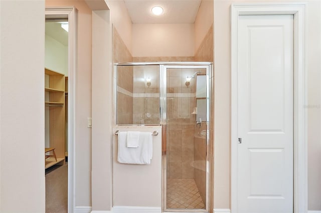 bathroom featuring a shower with door