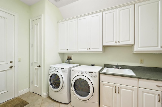 laundry area featuring cabinets, separate washer and dryer, sink, and light tile patterned floors