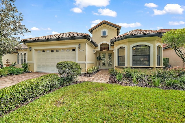 mediterranean / spanish-style house featuring a garage and a front lawn