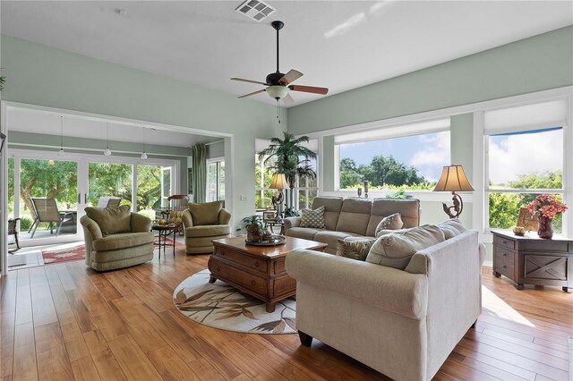 living room featuring wood-type flooring and ceiling fan