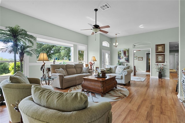 living room with light hardwood / wood-style flooring, ceiling fan, and a healthy amount of sunlight