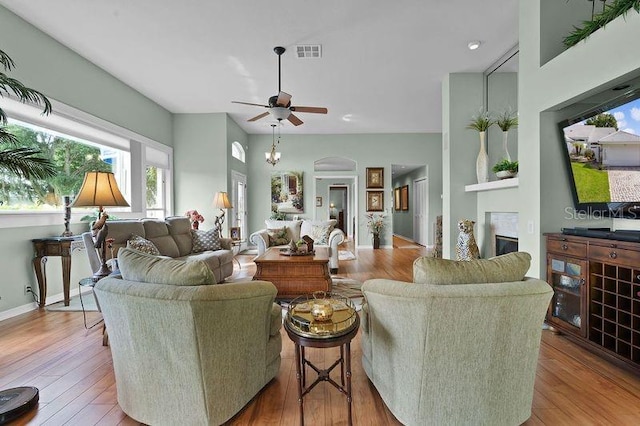 living room with hardwood / wood-style floors and ceiling fan