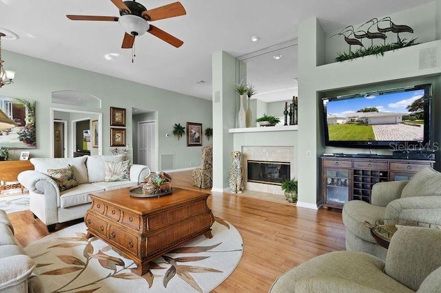 living room with ceiling fan and light wood-type flooring