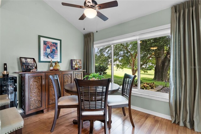 dining room featuring light hardwood / wood-style flooring, ceiling fan, and vaulted ceiling