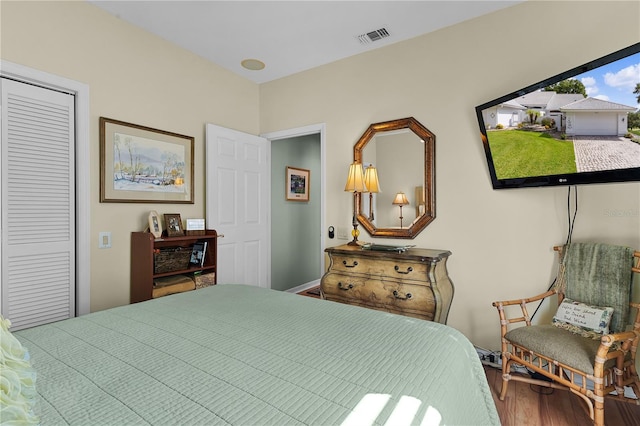 bedroom featuring wood-type flooring and a closet