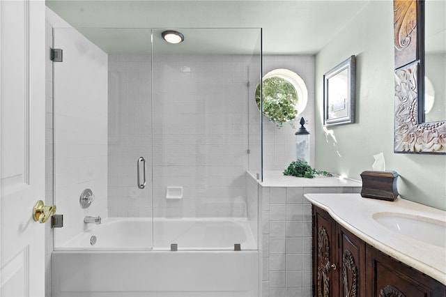 bathroom featuring vanity and enclosed tub / shower combo