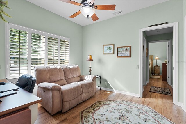 office space featuring ceiling fan and light hardwood / wood-style floors