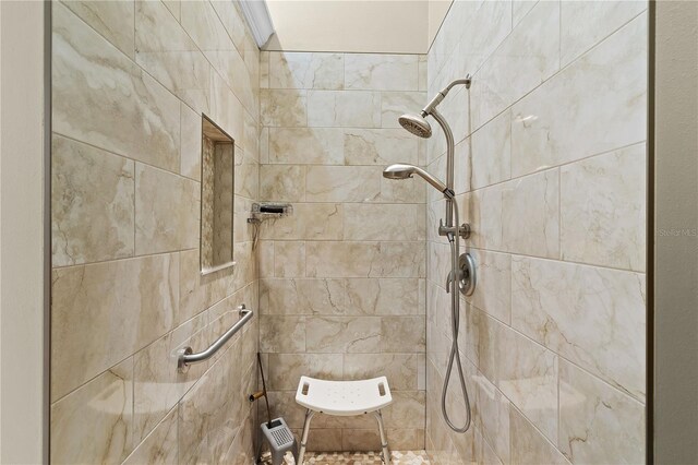 interior details featuring tiled shower