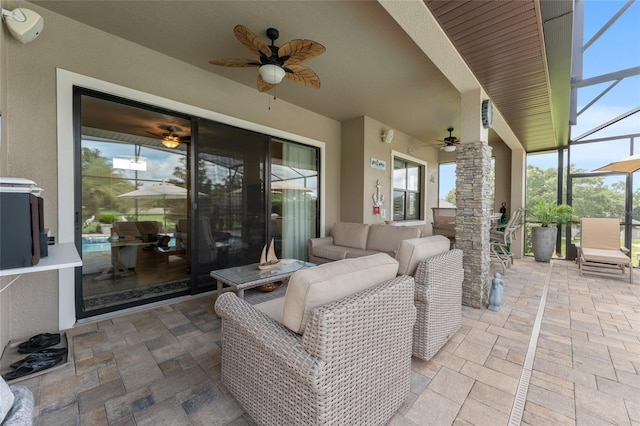 view of patio with ceiling fan, a lanai, and an outdoor hangout area