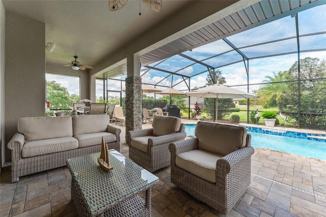 view of patio / terrace with an outdoor living space, ceiling fan, and a lanai