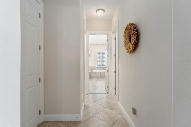 hall featuring light tile patterned floors