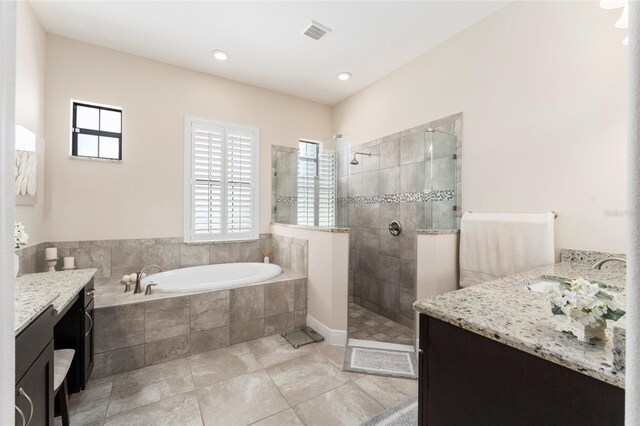 bathroom featuring vanity, separate shower and tub, and tile patterned floors