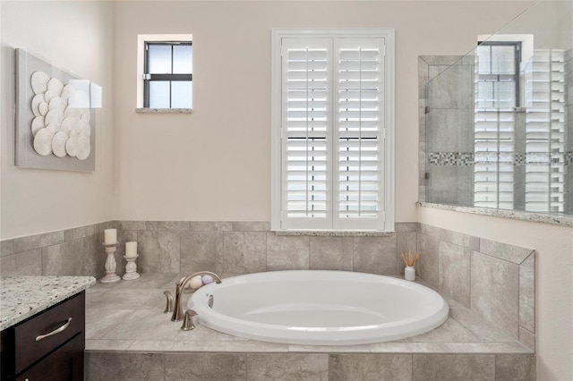 bathroom with vanity and independent shower and bath