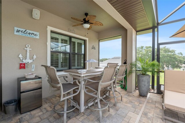 sunroom featuring ceiling fan