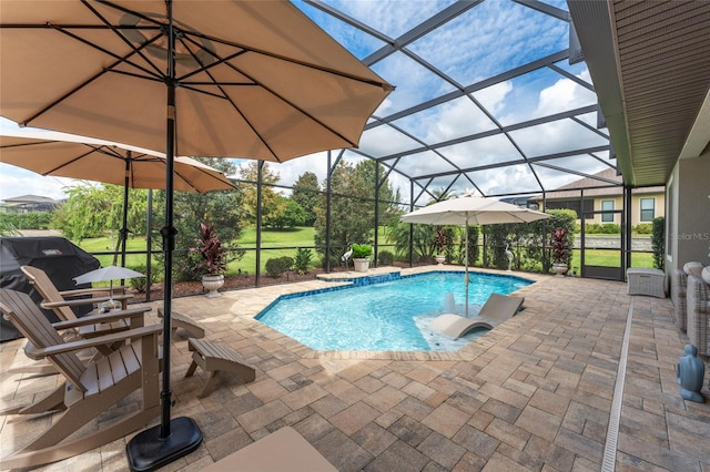 view of swimming pool with glass enclosure, grilling area, and a patio