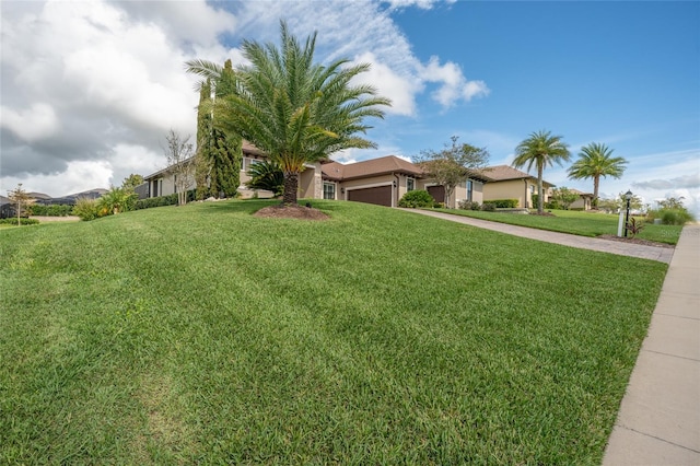 view of front of property with a garage and a front lawn