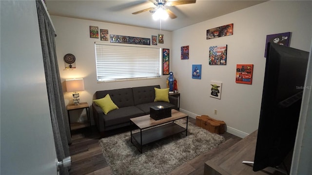 living room featuring ceiling fan and dark hardwood / wood-style flooring