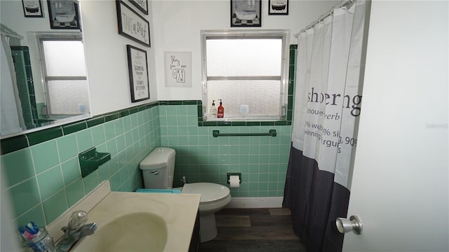 bathroom featuring hardwood / wood-style floors, toilet, sink, and a healthy amount of sunlight