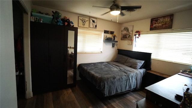 bedroom with dark wood-type flooring and ceiling fan