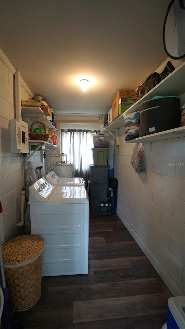 clothes washing area with dark wood-type flooring and independent washer and dryer