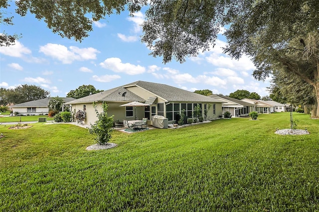 back of house featuring a yard and a patio