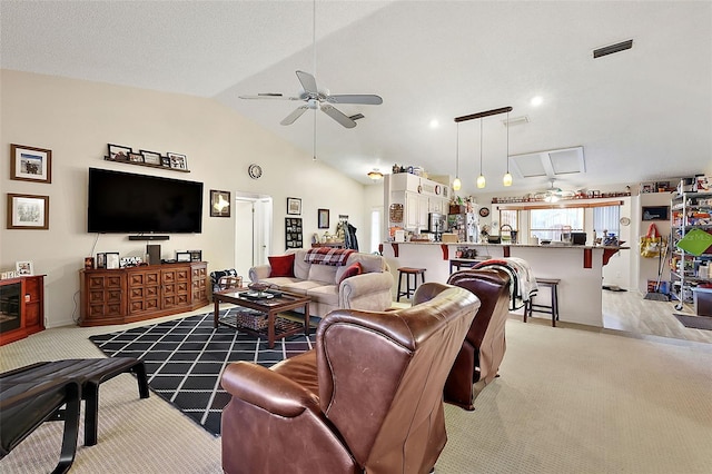 carpeted living room with vaulted ceiling and ceiling fan