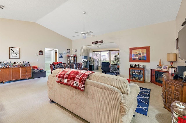 carpeted living room featuring vaulted ceiling and ceiling fan