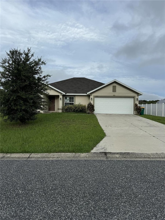 view of front of house featuring a front yard and a garage