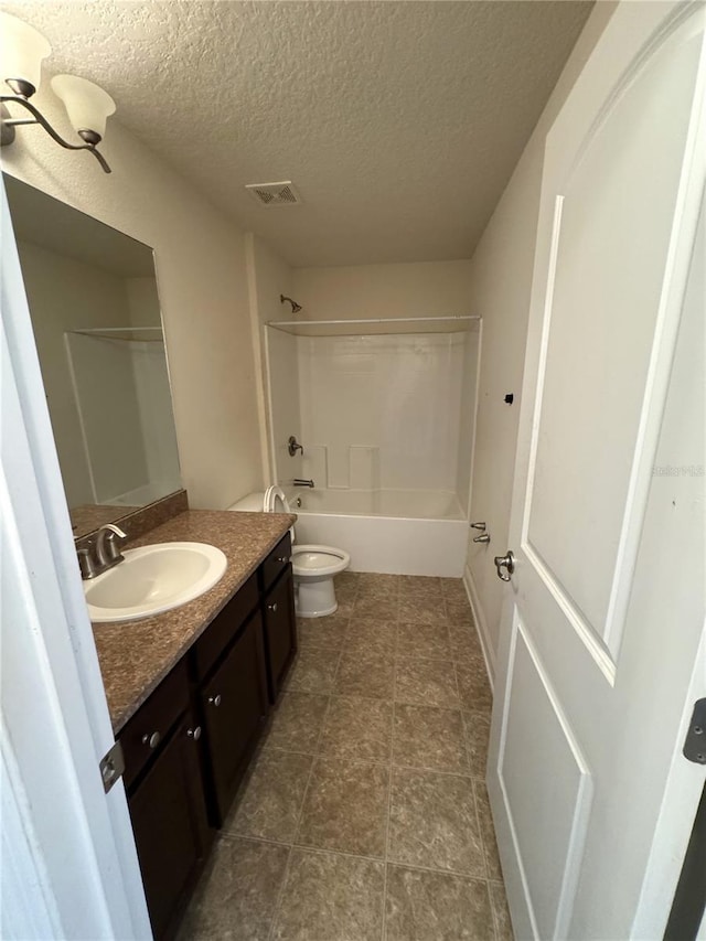 full bathroom with vanity, toilet, a textured ceiling, and bathing tub / shower combination