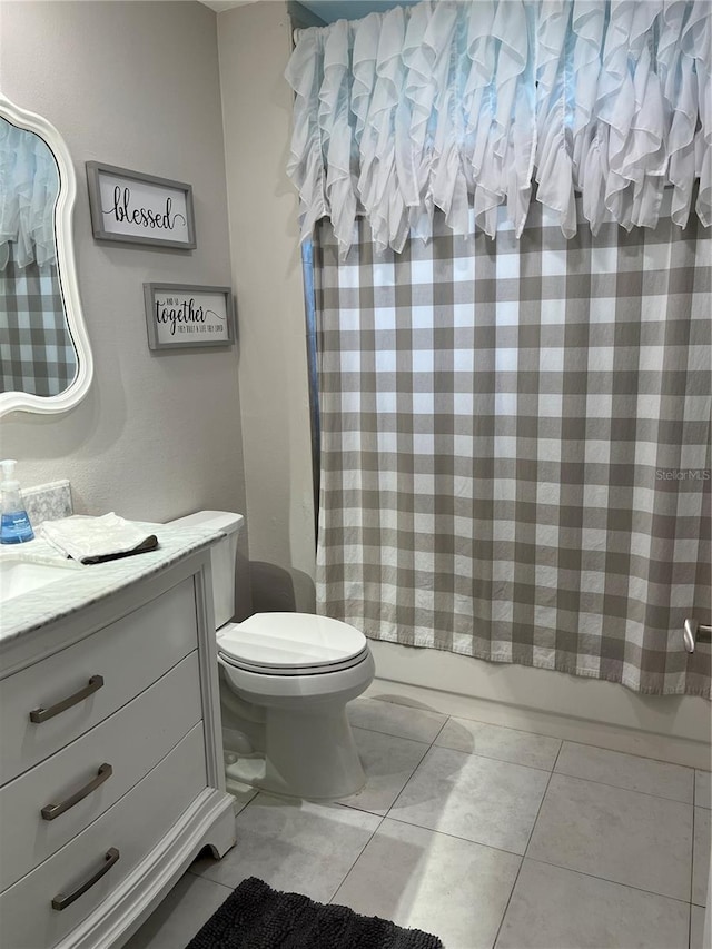 full bathroom with vanity, toilet, tile patterned floors, and shower / bath combo with shower curtain