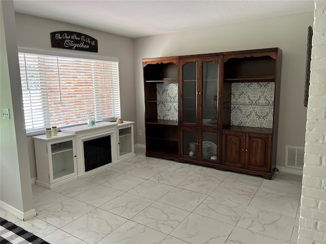 unfurnished living room with a textured ceiling