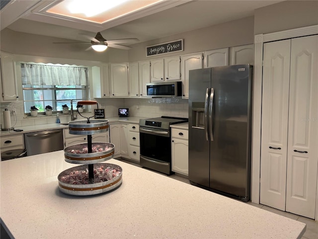 kitchen featuring white cabinetry, appliances with stainless steel finishes, and decorative backsplash