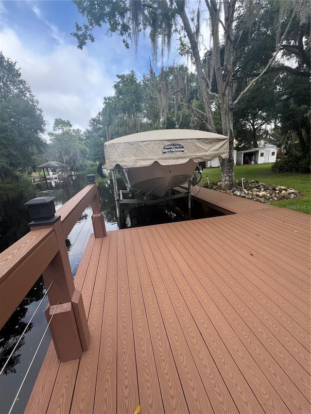 deck with a water view and a boat dock