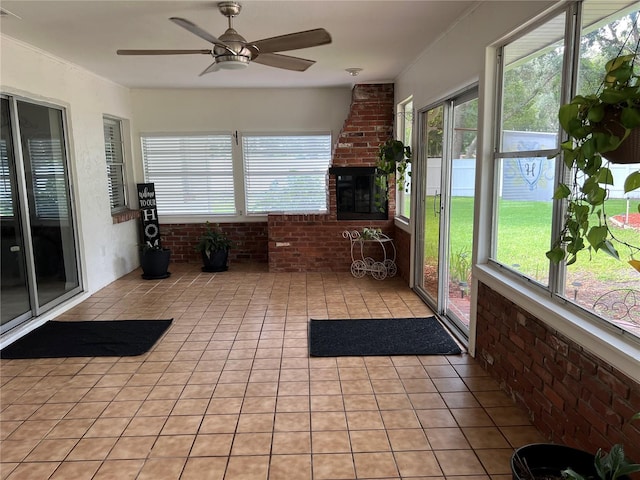 unfurnished sunroom with ceiling fan and a healthy amount of sunlight