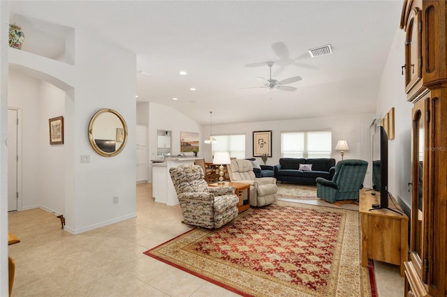 tiled living room with lofted ceiling and ceiling fan