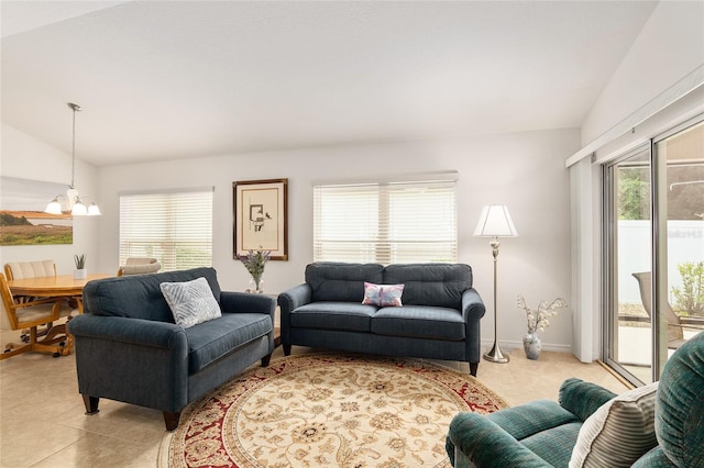 living room featuring a notable chandelier, a healthy amount of sunlight, vaulted ceiling, and light tile patterned floors