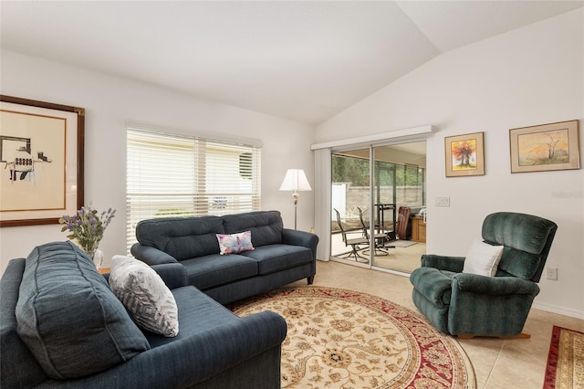 living room with plenty of natural light, vaulted ceiling, and light tile patterned floors