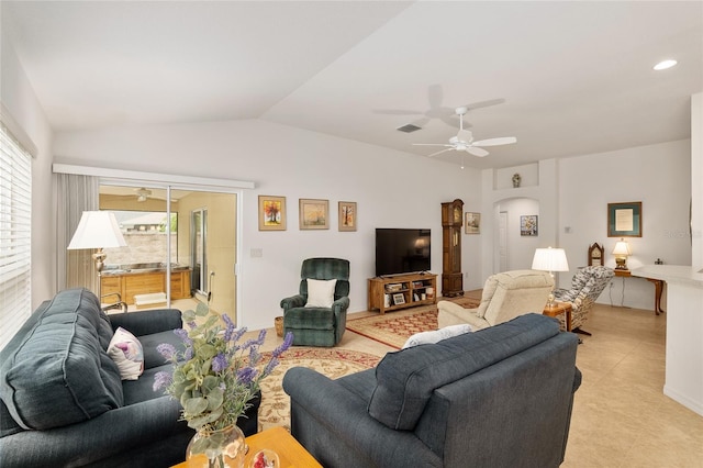 living room featuring ceiling fan and lofted ceiling