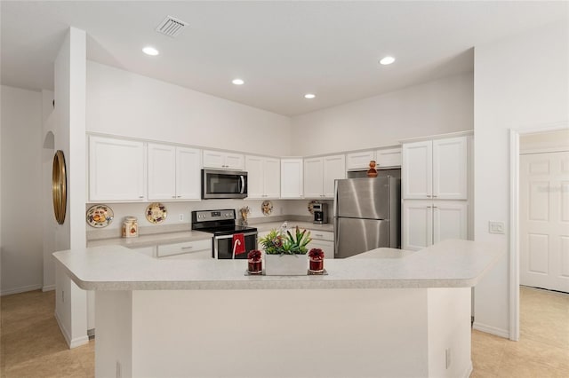 kitchen with stainless steel appliances, white cabinetry, a breakfast bar area, a center island with sink, and light tile patterned floors