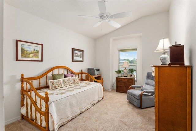 bedroom featuring ceiling fan, vaulted ceiling, and light colored carpet