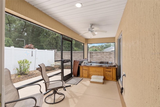 sunroom featuring ceiling fan